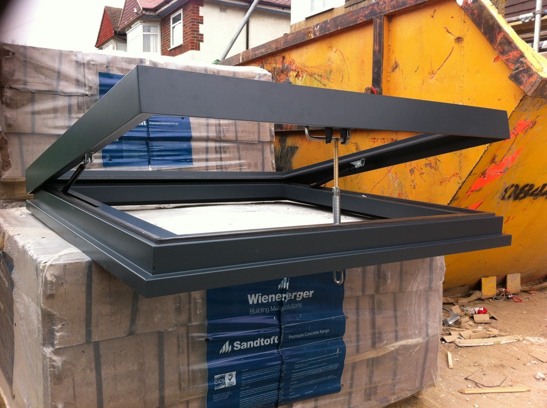 Opening flat roof skylight in anthracite grey installed in Parson's Green